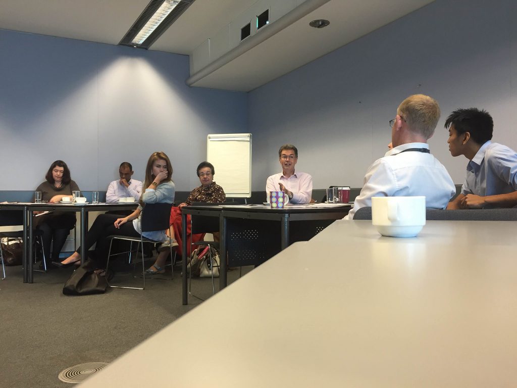 A group of people discuss ideas at London City Hall