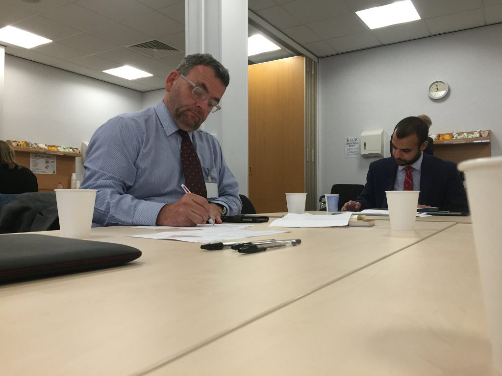 Two men work at a table in an office