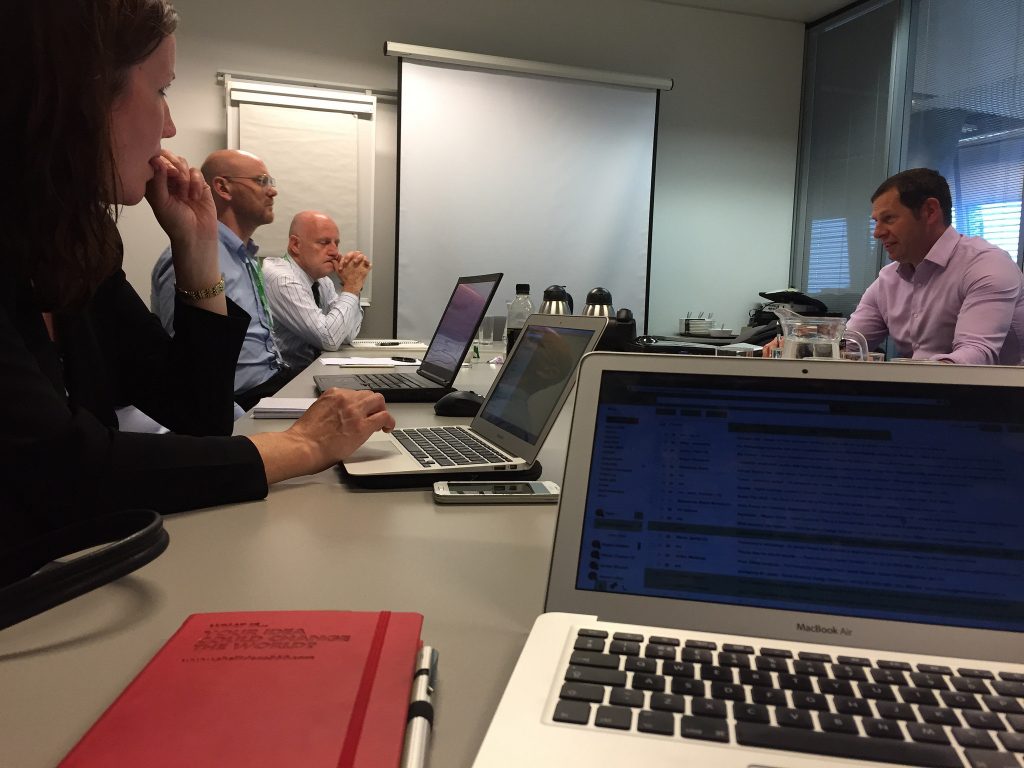 A meeting with laptops in an office