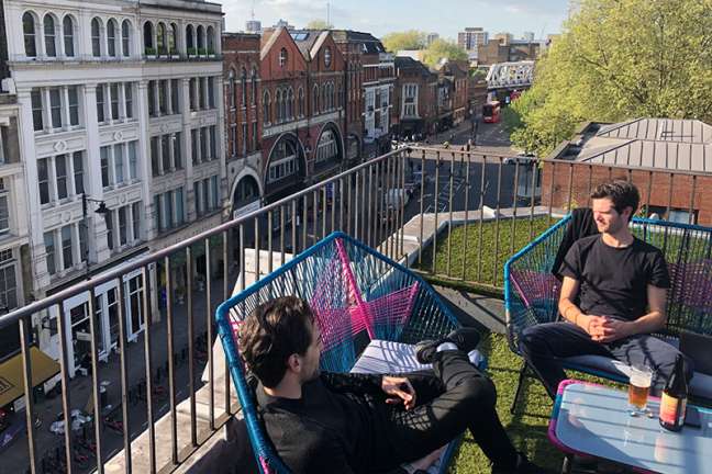People sit in the rooftop area of our London HQ