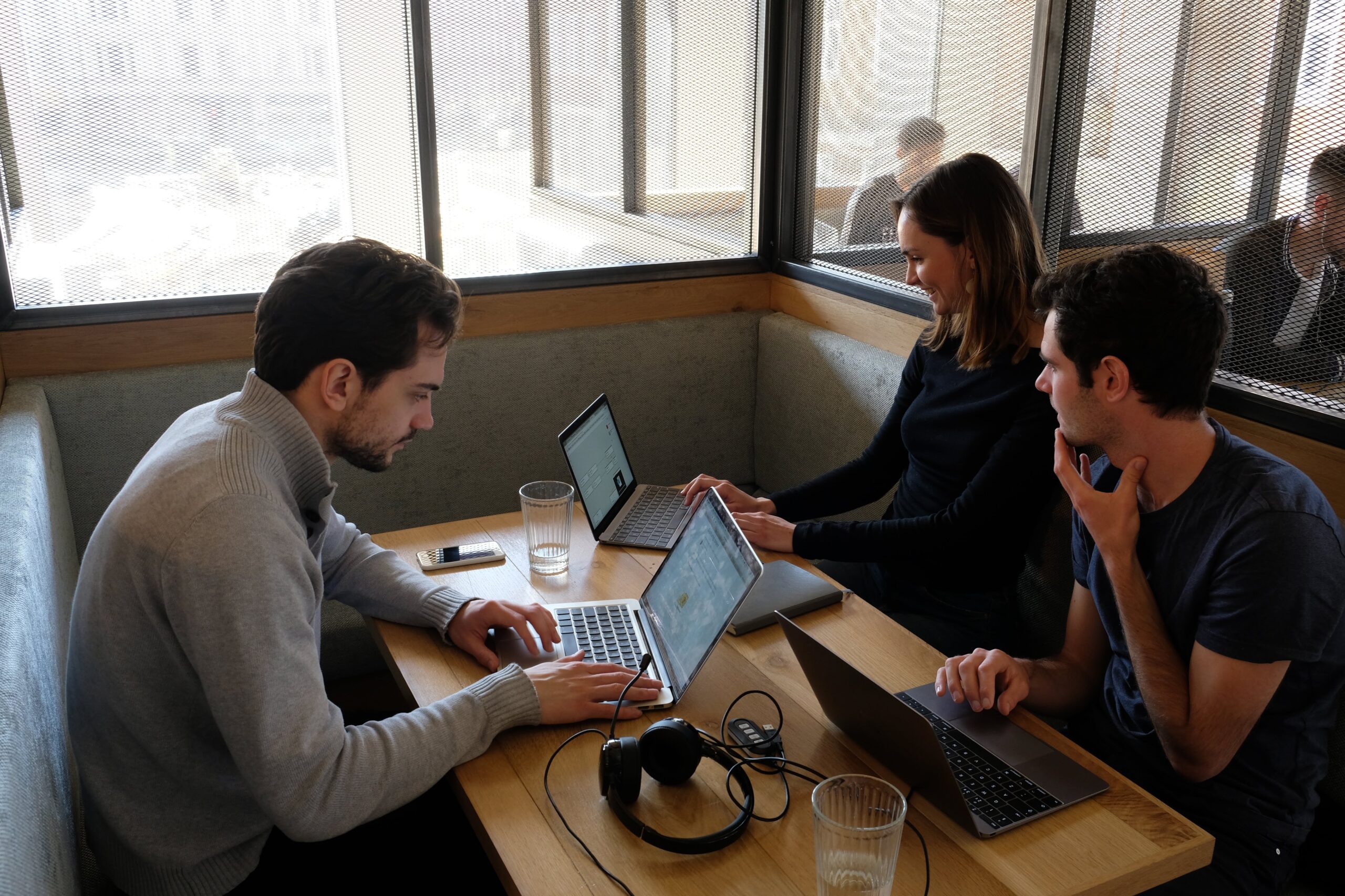 A small dev team work at a table as part of our hackathon