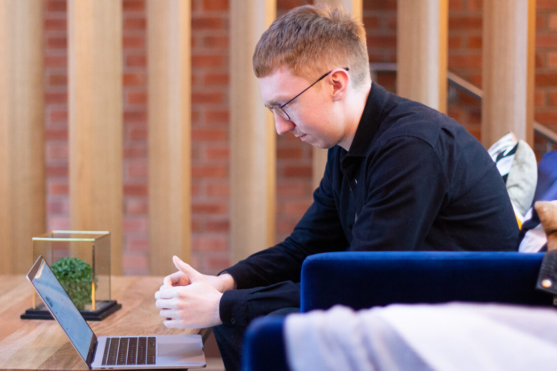 person sat overlooking a laptop