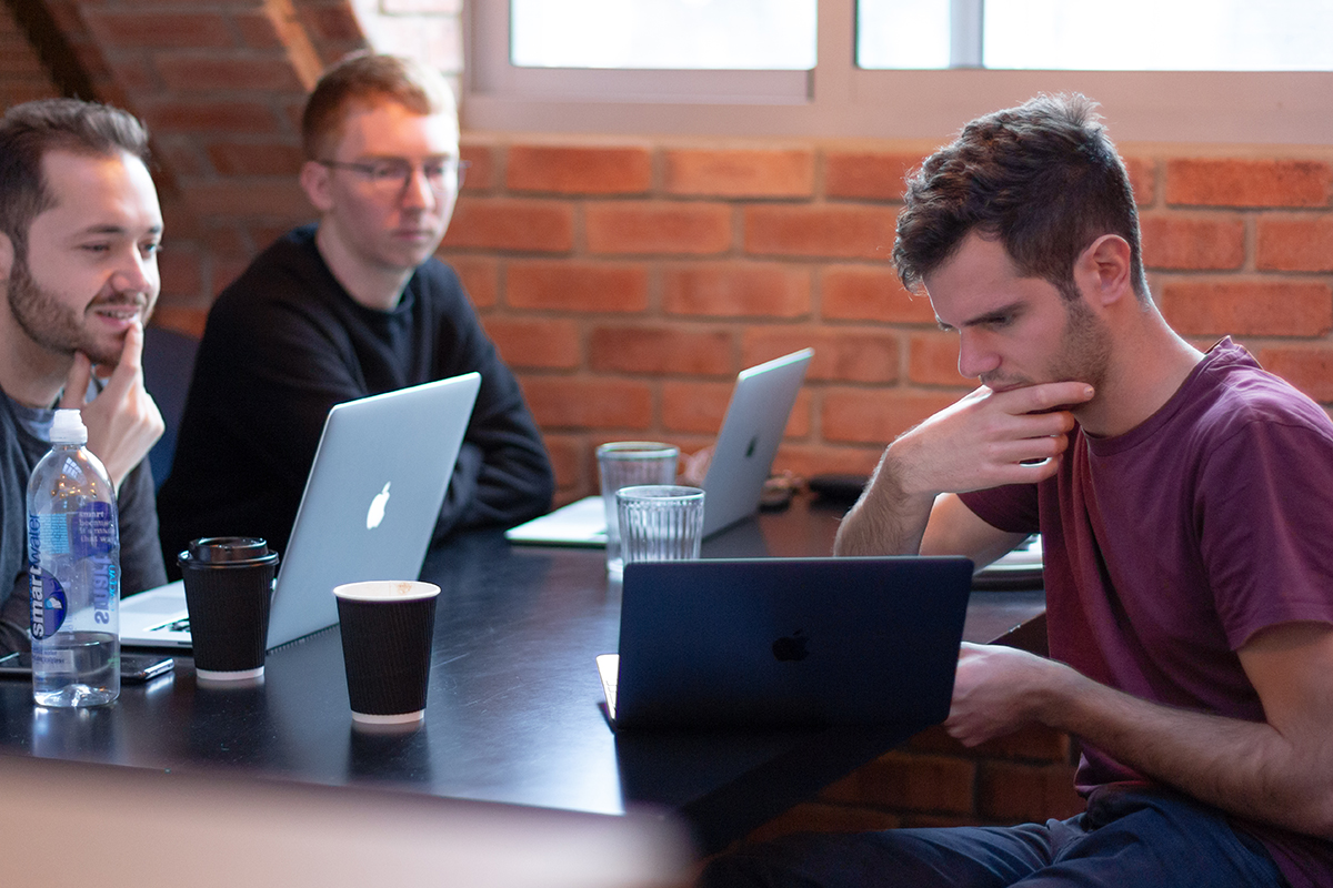 Three digital designers work on laptops at JAMS 2018