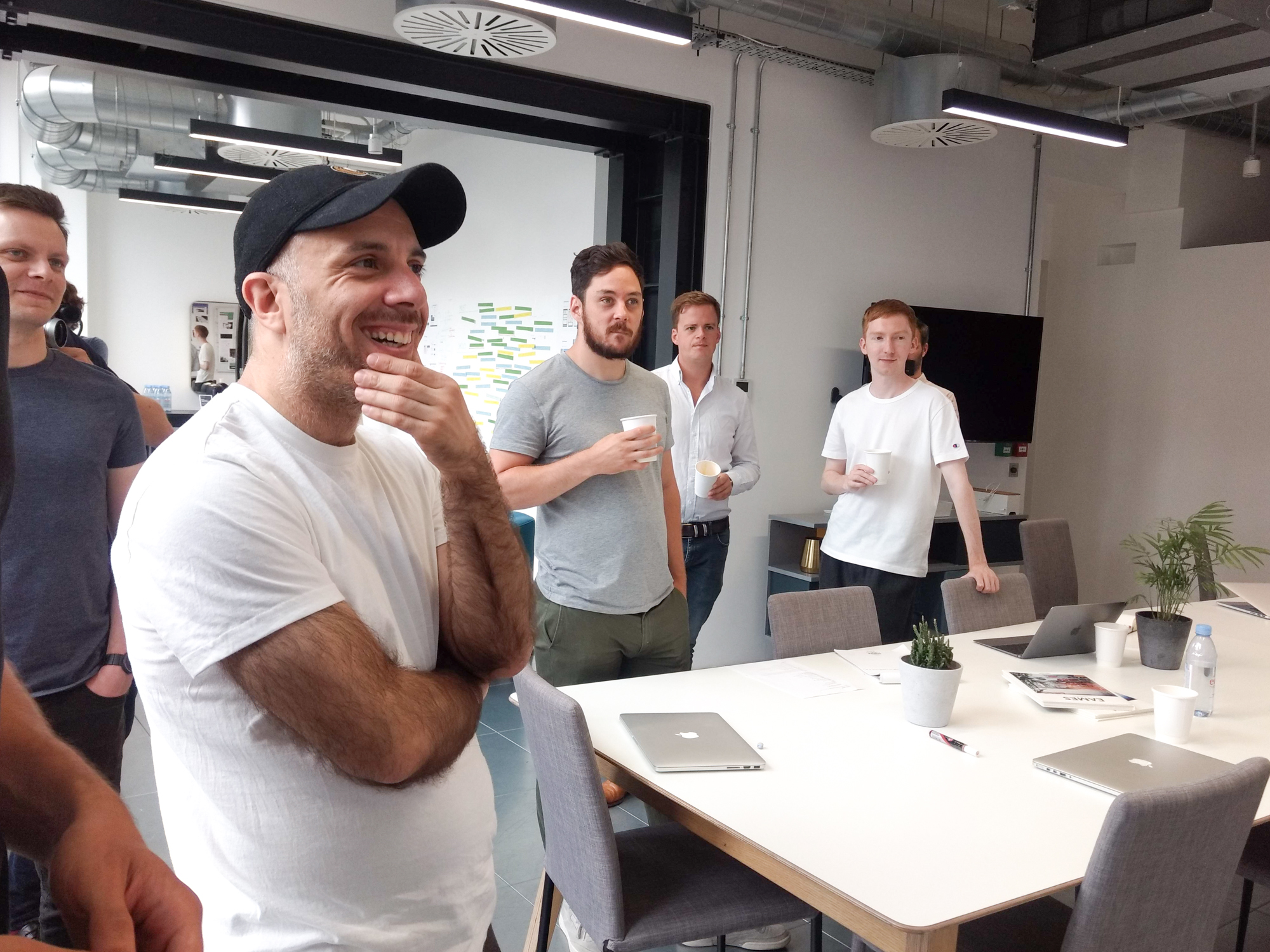 A team stand around and watch a presentation about updating the Browser hosting platform and infrastructure