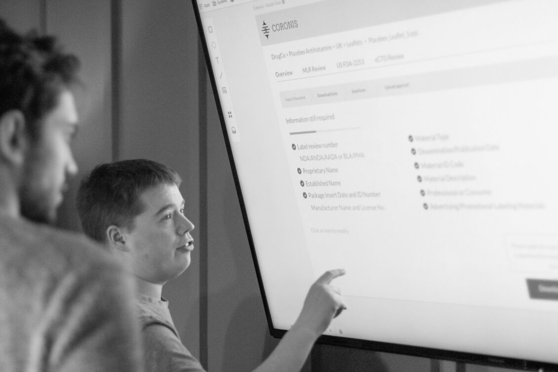A group of users give feedback on a website design on a large screen